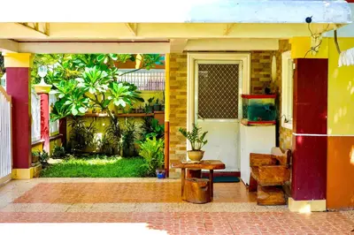 a front door of a house with a table at Entire House with 4 rooms near SM Molino and Vermosa Ayala in Imus