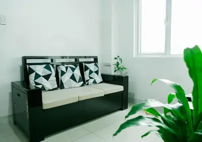 a black bed in a white room with plants at Salem's Abode in Manila