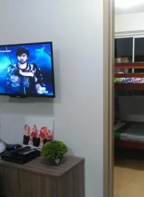 a living room with a television on a wall at 2 BR Sorrento Oasis in Manila