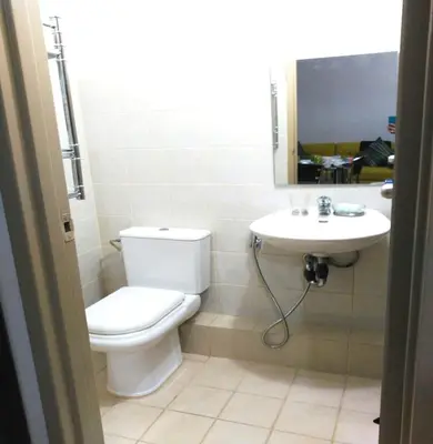 a bathroom with a toilet and a sink at 2 BR Sorrento Oasis in Manila