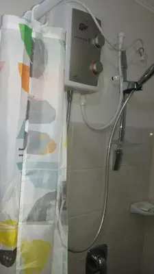 a shower in a bathroom with a shower curtain at 2 BR Sorrento Oasis in Manila