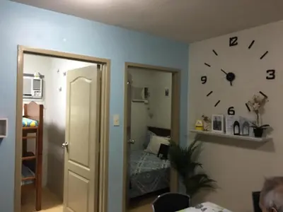 a room with a mirror and a clock on the wall at 2 BR Sorrento Oasis in Manila