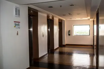 a hallway with elevators in a building with a window at Titan Condo at Studio City Tower 1 Alabang in Manila