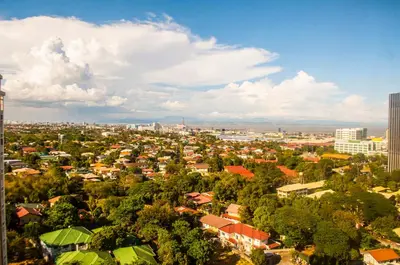 a view of a city with trees and buildings at Titan Condo at Studio City Tower 1 Alabang in Manila