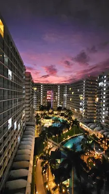 a view of a city at night with buildings at The Palawanos Home at Shell Residences in Manila