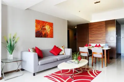 a living room with a couch and a table at Valero Grand Suites by Swiss-Belhotel in Manila