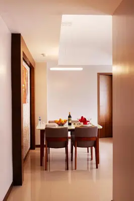 a kitchen and dining room with a table and chairs at Valero Grand Suites by Swiss-Belhotel in Manila