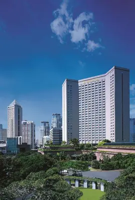 a large building with a park in front of a city at Makati Shangri-La, Manila in Manila