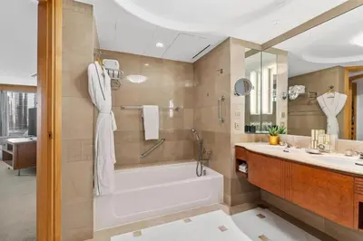 a bathroom with a tub and a sink at Makati Shangri-La, Manila in Manila