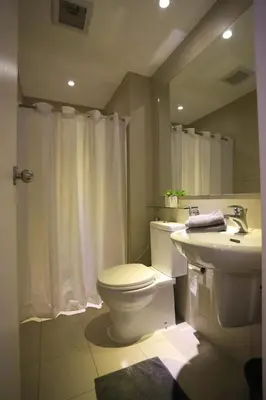 a bathroom with a toilet and a sink at Maui Condotel Azure Residence in Manila