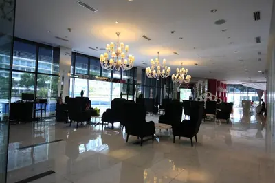 a lobby with chairs and tables and chandeliers at Maui Condotel Azure Residence in Manila