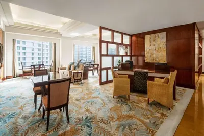 a living room with a table and chairs at Edsa Shangri-La, Manila in Manila