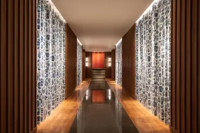 a hallway with blue and white patterned walls at Edsa Shangri-La, Manila in Manila