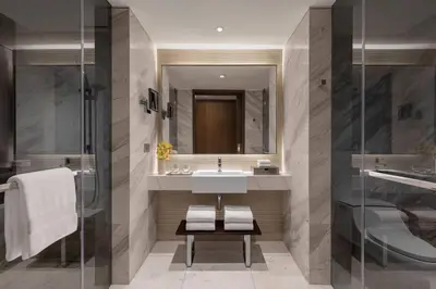 a bathroom with a sink and a mirror at Manila Marriott Hotel at Newport World Resorts in Manila