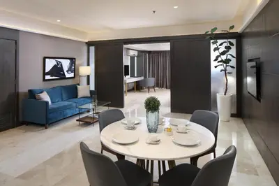 a living room with a table and chairs at City Garden Suites Manila in Manila