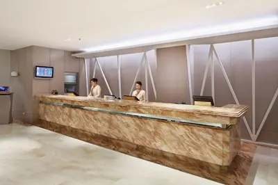 two people sitting at a bar in a hotel lobby at City Garden Suites Manila in Manila