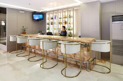 a bar in a hotel with stools around it at City Garden Suites Manila in Manila