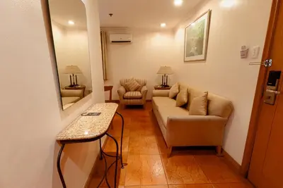 a living room with a couch and a chair at City Garden Suites Manila in Manila