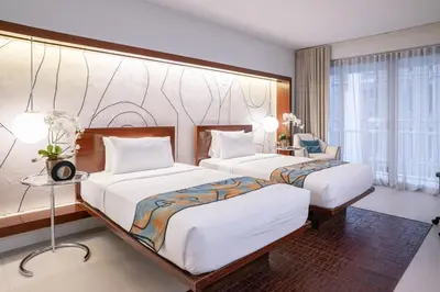 a hotel room with two beds and a table at The Picasso Boutique Serviced Residences Managed by HII in Manila