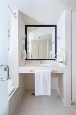 a bathroom with a sink and a mirror at The Picasso Boutique Serviced Residences Managed by HII in Manila