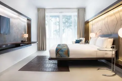 a bedroom with a large bed and a large window at The Picasso Boutique Serviced Residences Managed by HII in Manila
