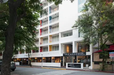 a tall white building with a store in front of it at The Picasso Boutique Serviced Residences Managed by HII in Manila