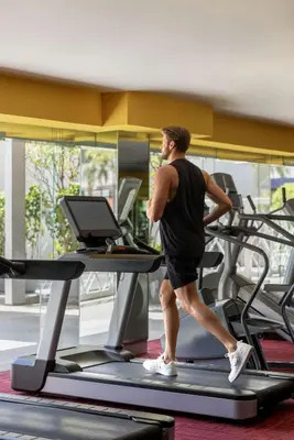 a man running on a treadmill in a gym at Dusit Thani Manila in Manila