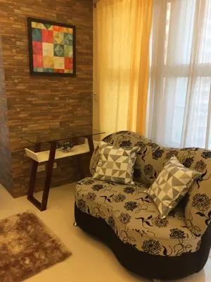 a living room with a couch and a table at Luckycat Homestay in Manila