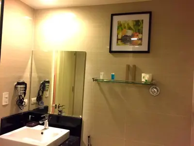 a bathroom with a sink and a mirror at Luckycat Homestay in Manila
