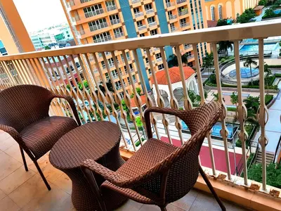 a balcony with chairs and a view of a city at Luckycat Homestay in Manila
