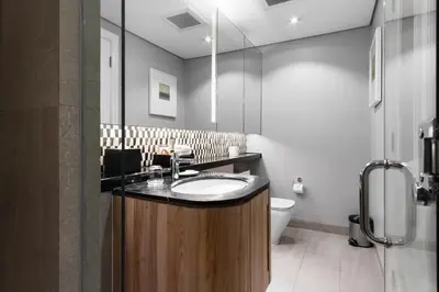 a bathroom with a sink and a toilet at Ascott Makati in Manila