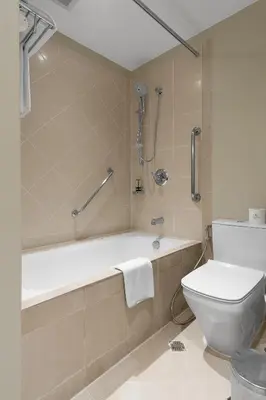 a bathroom with a bath tub and a toilet at Ascott Makati in Manila
