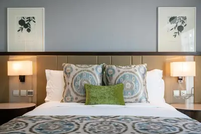 a bedroom with a large bed with two pillows at Ascott Makati in Manila
