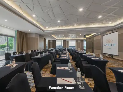 a conference room with tables and chairs and a screen at Ascott Makati in Manila
