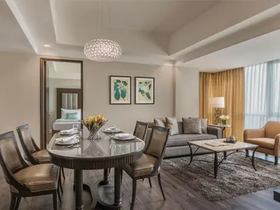 a living room with a table and a couch at Somerset Millennium Makati in Manila