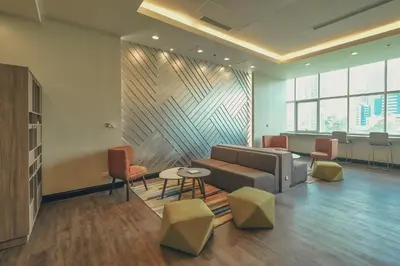 a waiting room with a couch and chairs at Somerset Millennium Makati in Manila