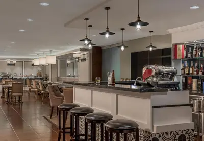 a bar in a restaurant with stools at Somerset Millennium Makati in Manila