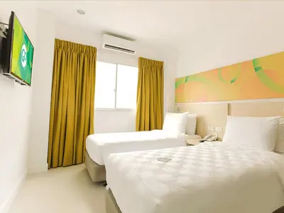 a hotel room with two beds and a window at Go Hotels Ermita, Manila in Manila