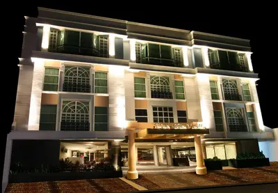 a building with a lit up facade at night at Crown Regency Hotel Makati in Manila