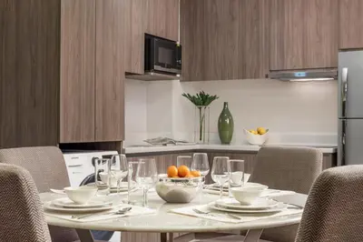 a table with a bowl of oranges on it in a kitchen at Citadines Millennium Ortigas Manila in Manila