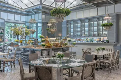 a rendering of a restaurant with tables and chairs at Citadines Millennium Ortigas Manila in Manila