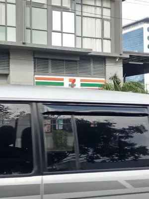 a white van parked in front of a building at Chin's Place Sea Residences MOA in Manila