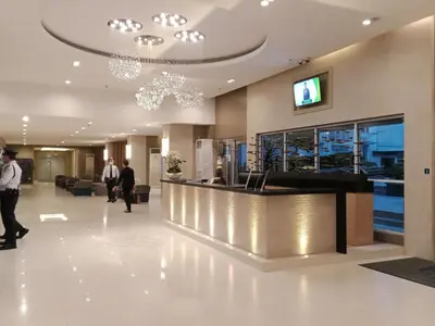 a lobby of a hotel with a reception counter at Chin's Place Sea Residences MOA in Manila