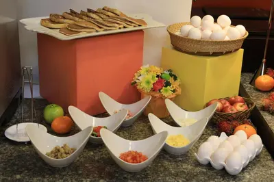 a table topped with eggs and other at The Malayan Plaza Hotel in Manila