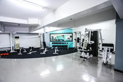 a gym with several treadmills and machines at The Malayan Plaza Hotel in Manila