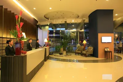 a lobby with people sitting at a counter in a store at The Malayan Plaza Hotel in Manila