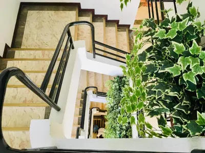 a stairway with stairs and plants on it at Jupiter Suites in Manila