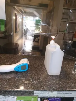 a bottle of detergent and a bottle of soap on a counter at Jupiter Suites in Manila