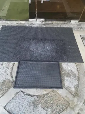a couple of black mats on a sidewalk at Jupiter Suites in Manila