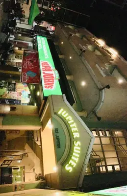 a sign in front of an airport at night at Jupiter Suites in Manila